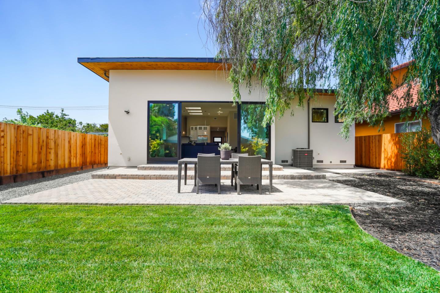 737 Ruby Street Redwood City, CA 94061 - Photo 24 of 26 a view of backyard of house with outdoor seating and green space