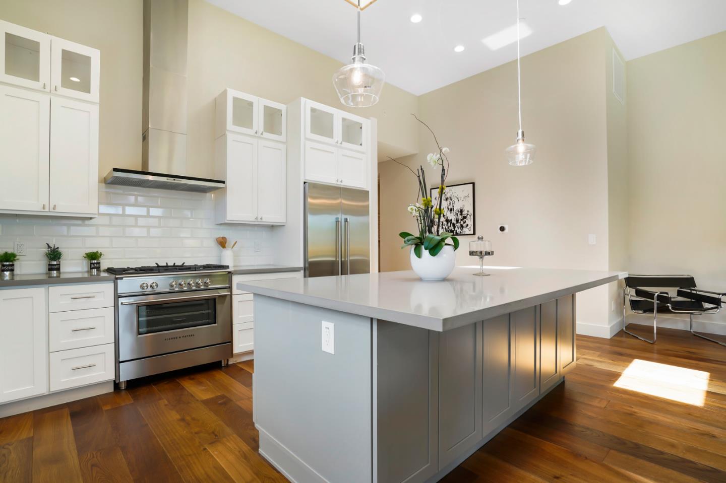737 Ruby Street Redwood City, CA 94061 - Photo 9 of 26 a kitchen with stainless steel appliances kitchen island granite countertop a stove and a sink
