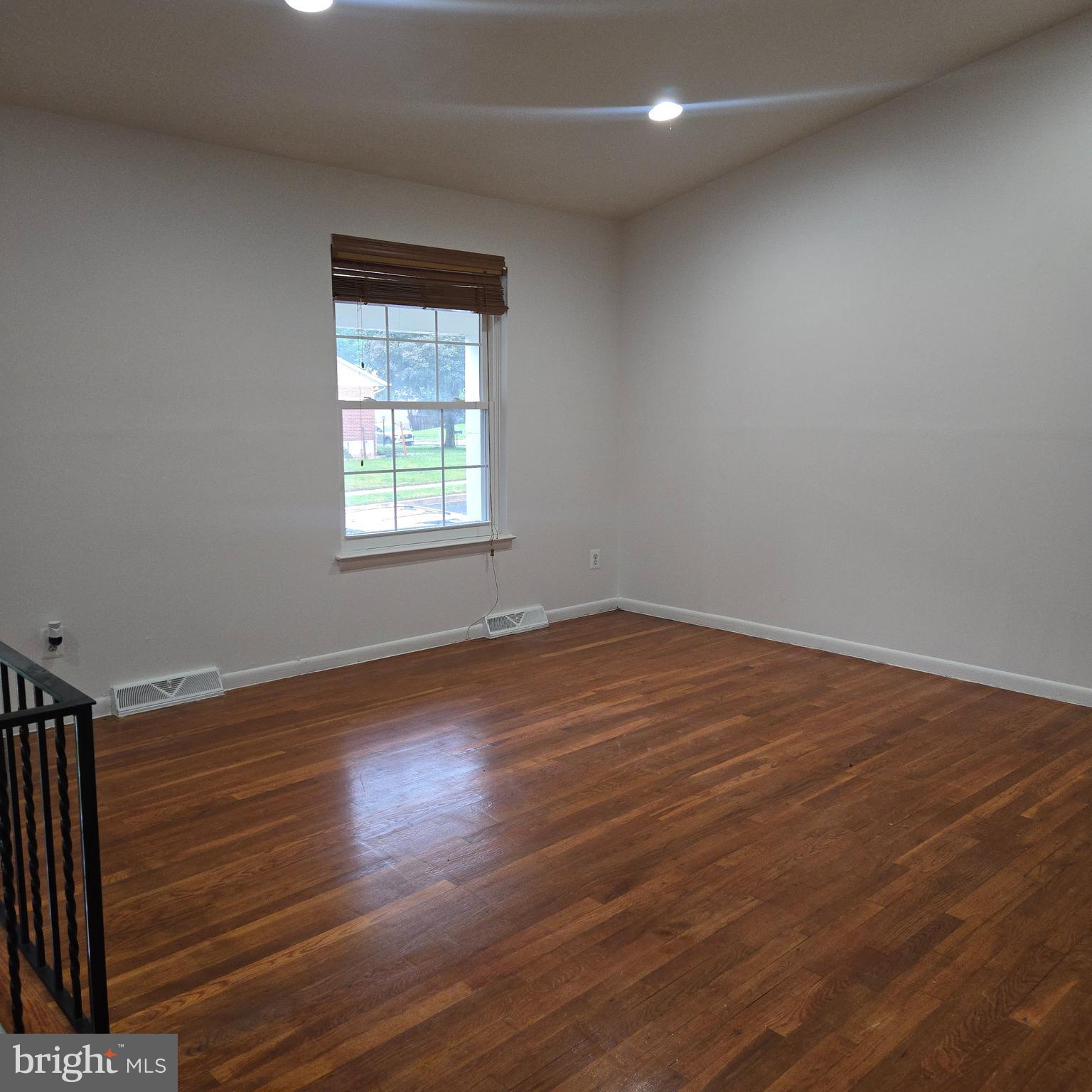 3505 Templar Road Randallstown, MD 21133 - Photo 5 of 40 an empty room with wooden floor and windows