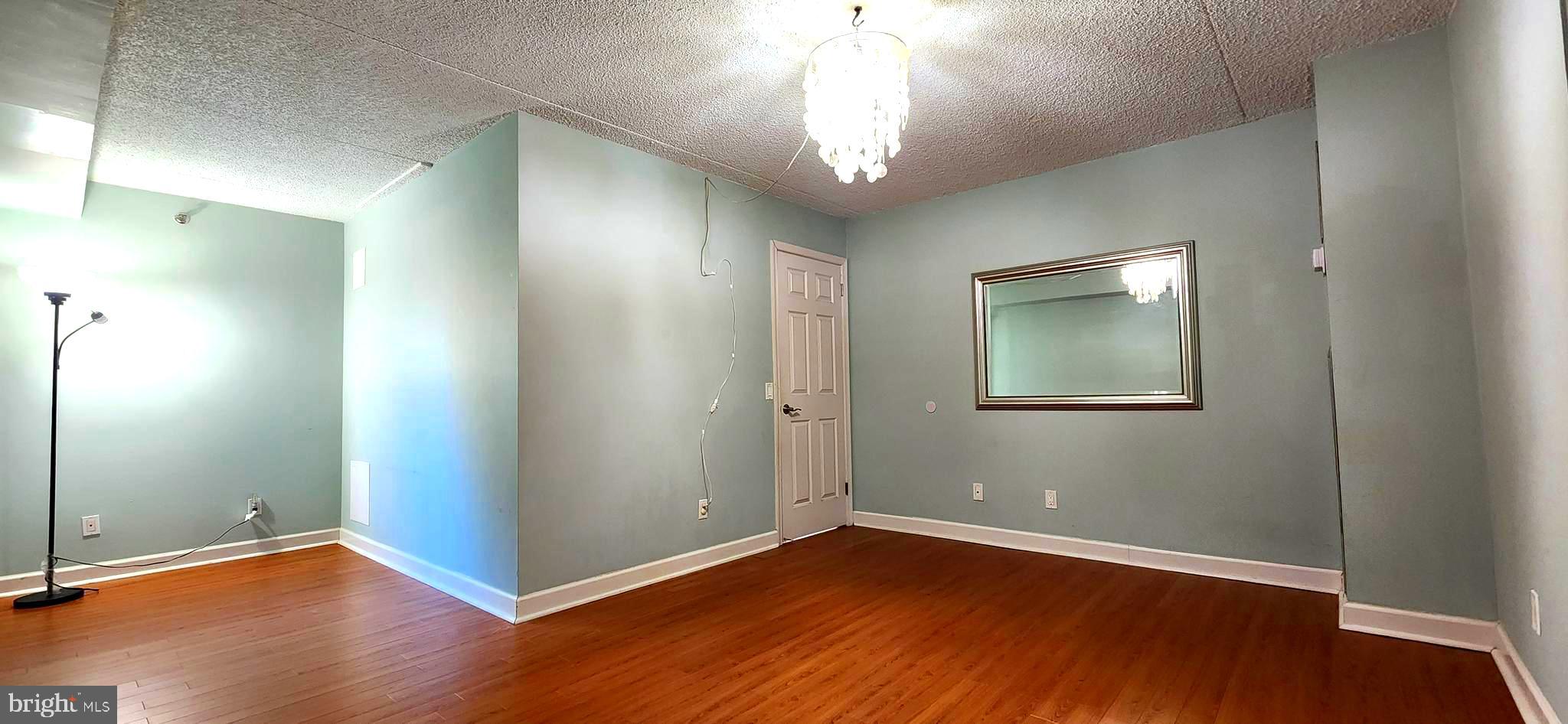 5911 Edsall Road, Unit 207 Alexandria, VA 22304 - Photo 12 of 22 an empty room with wooden floor and windows