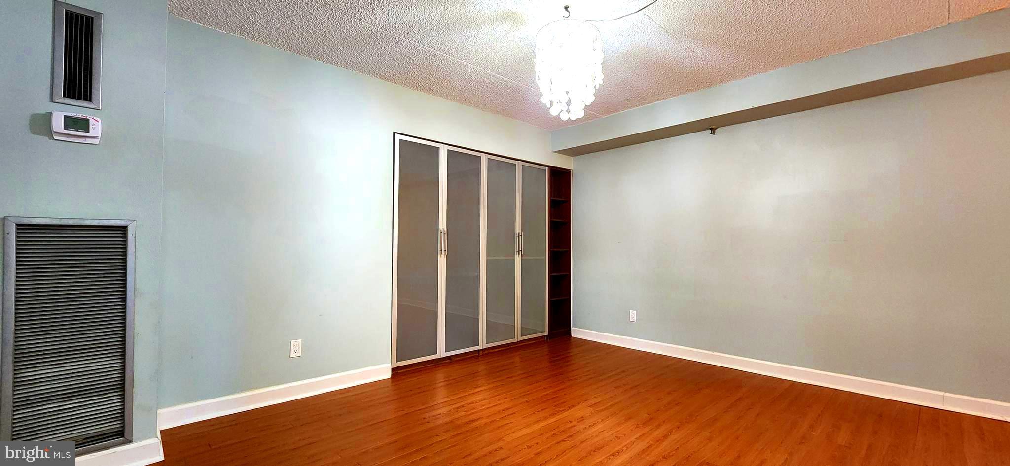 5911 Edsall Road, Unit 207 Alexandria, VA 22304 - Photo 13 of 22 a view of an empty room with wooden floor