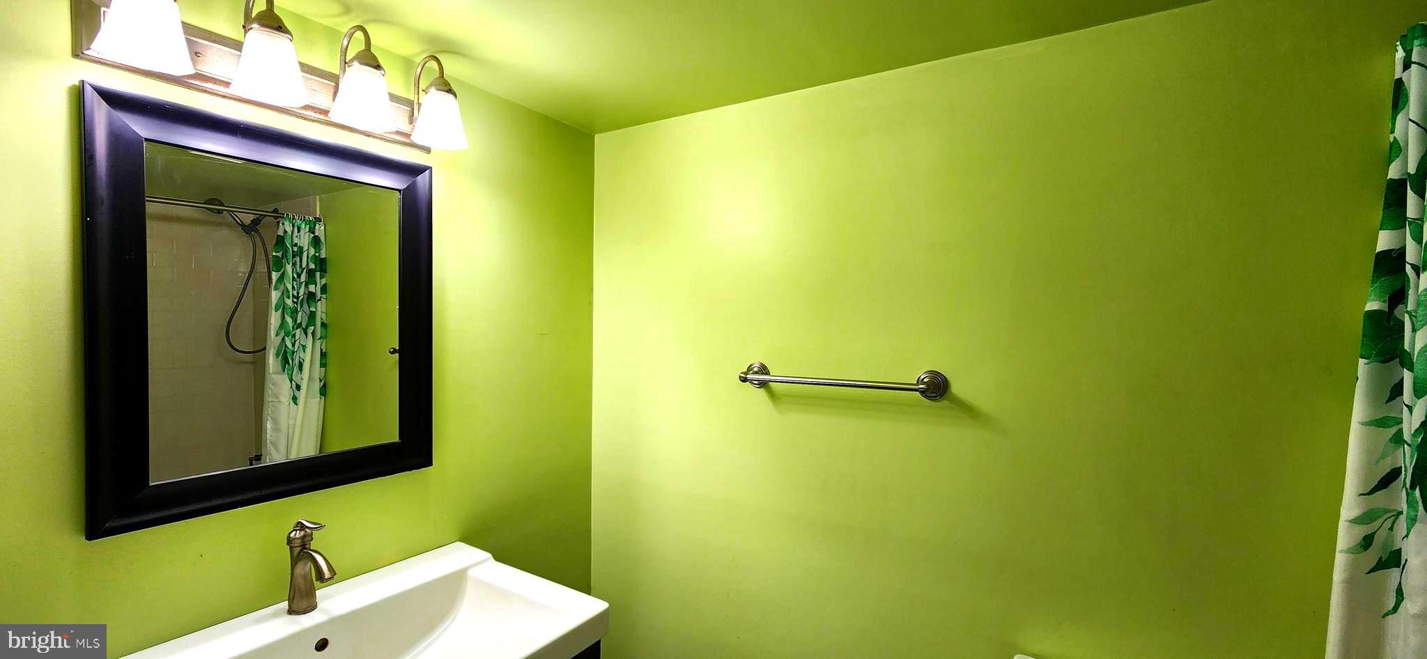 5911 Edsall Road, Unit 207 Alexandria, VA 22304 - Photo 14 of 22 a bathroom with a sink and a mirror