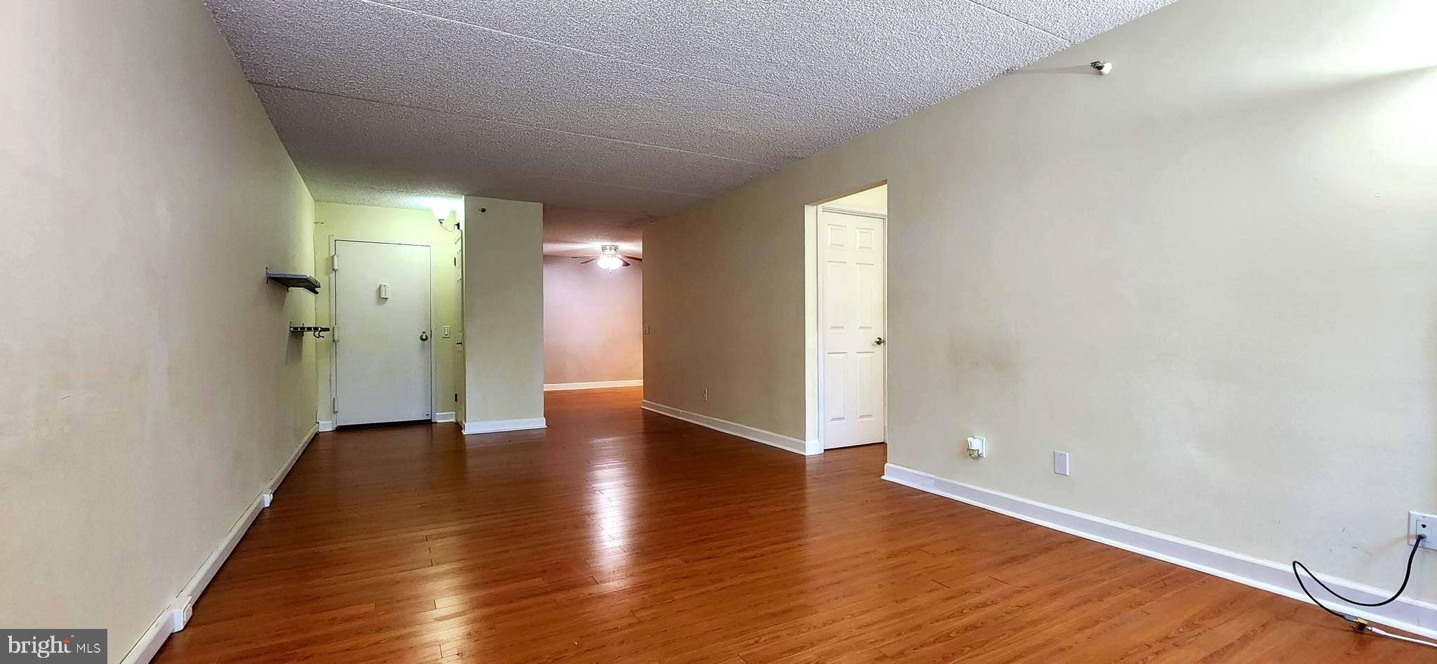5911 Edsall Road, Unit 207 Alexandria, VA 22304 - Photo 6 of 22 a view of an empty room with wooden floor