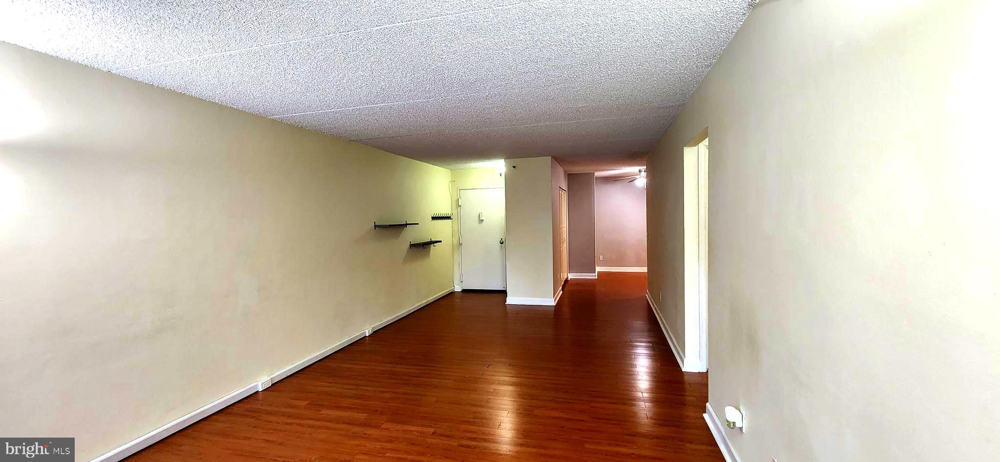 5911 Edsall Road, Unit 207 Alexandria, VA 22304 - Photo 7 of 22 a view of an empty room with wooden floor