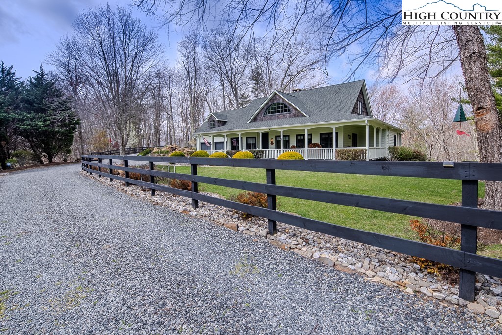 909 Daisy Ridge Road Banner Elk, NC 28604 - Photo 1 of 47 a front view of a house with a yard table and chairs