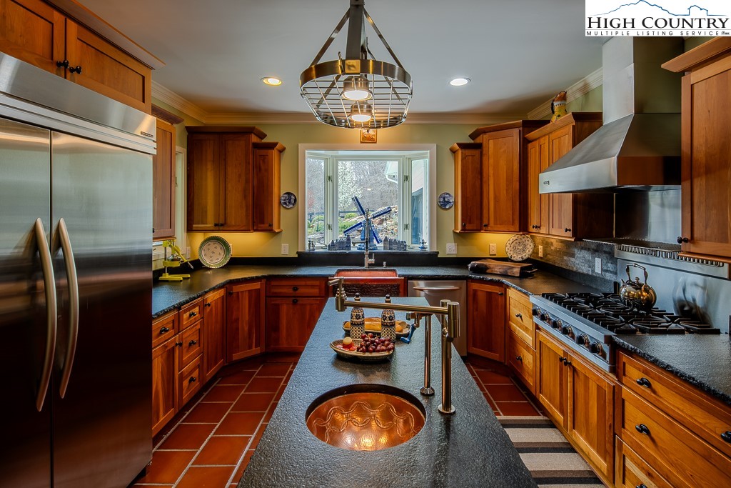 909 Daisy Ridge Road Banner Elk, NC 28604 - Photo 12 of 47 a kitchen with stainless steel appliances granite countertop a stove a refrigerator and a microwave