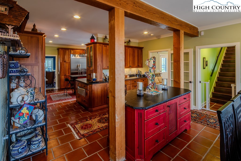 909 Daisy Ridge Road Banner Elk, NC 28604 - Photo 15 of 47 a kitchen with lots of clutter and appliances