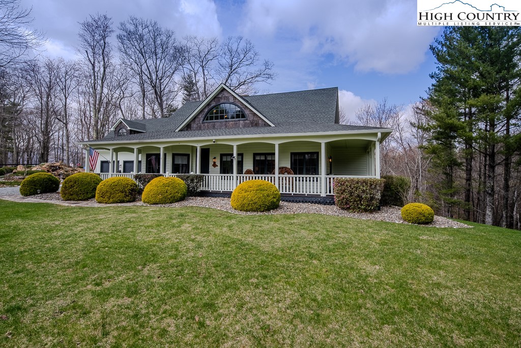 909 Daisy Ridge Road Banner Elk, NC 28604 - Photo 2 of 47 a view of a house with a backyard and a tree