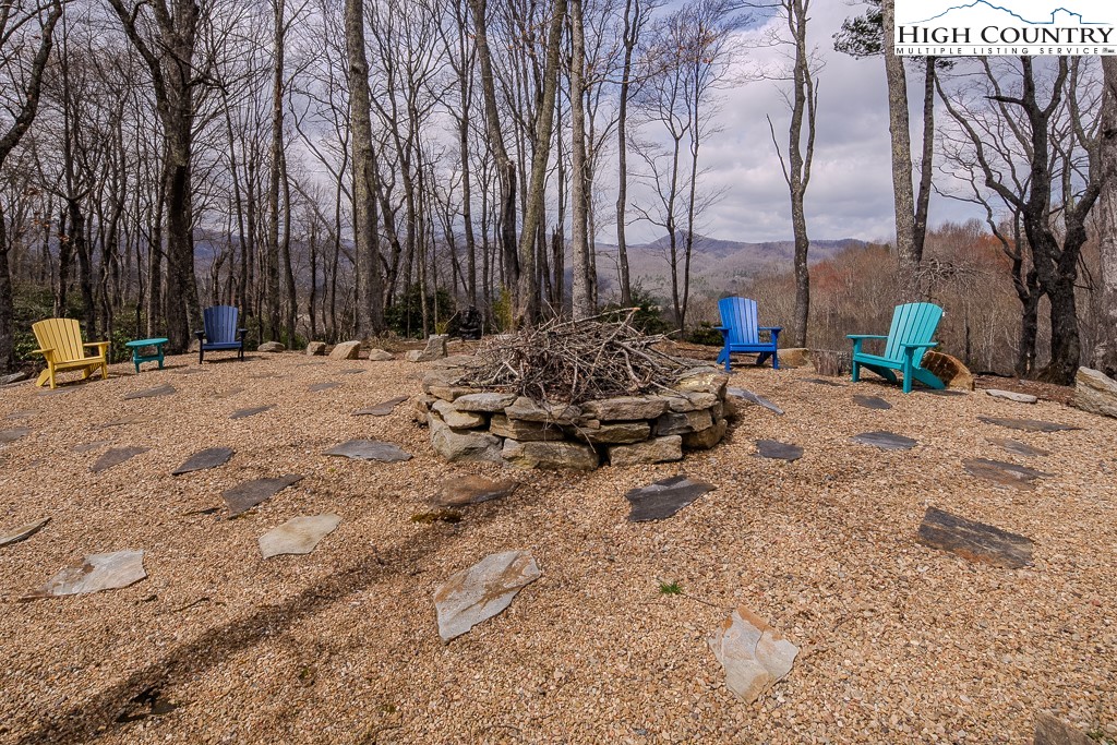 909 Daisy Ridge Road Banner Elk, NC 28604 - Photo 23 of 47 a view of a backyard with chairs and white walls