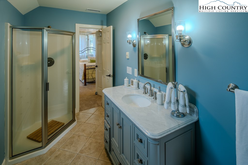 909 Daisy Ridge Road Banner Elk, NC 28604 - Photo 28 of 47 a bathroom with a sink a shower and a mirror