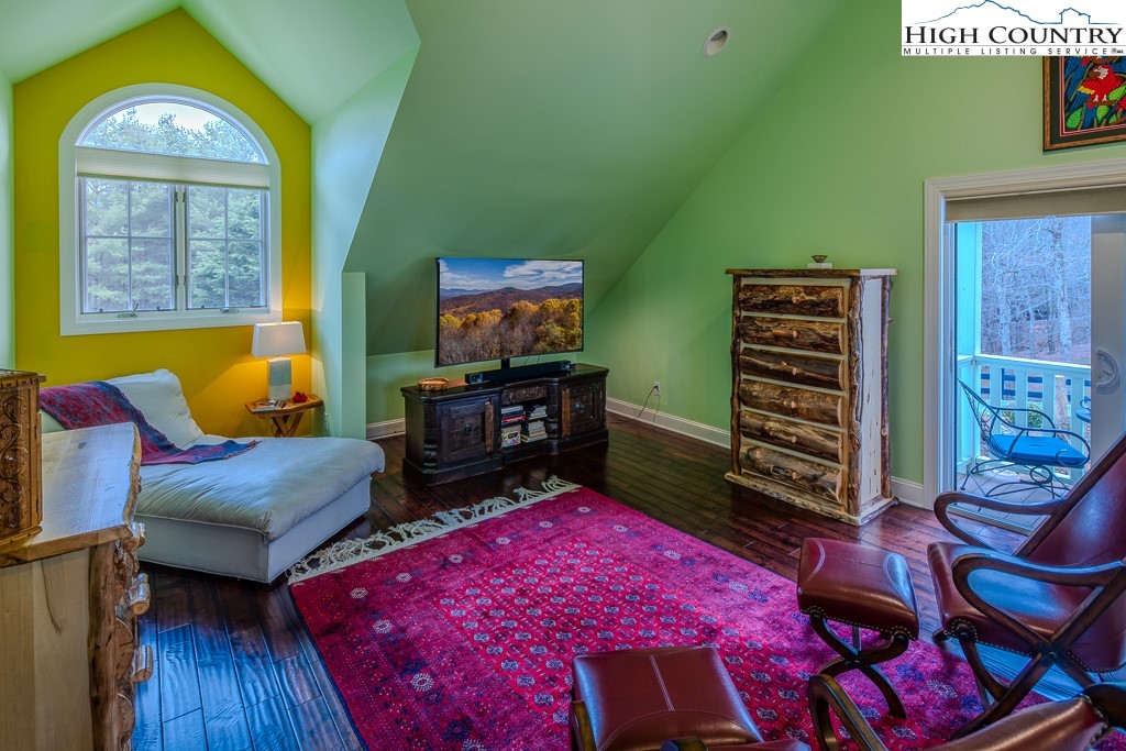 909 Daisy Ridge Road Banner Elk, NC 28604 - Photo 33 of 47 a bedroom with furniture and a flat screen tv