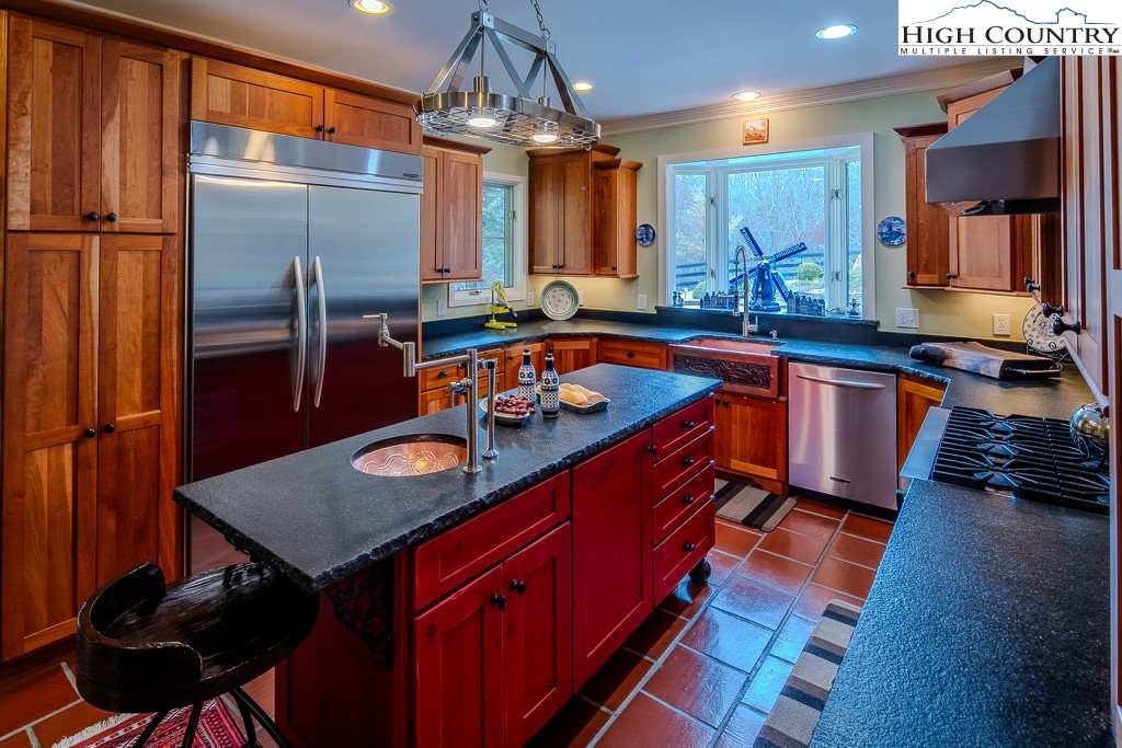 909 Daisy Ridge Road Banner Elk, NC 28604 - Photo 4 of 47 a kitchen with stainless steel appliances granite countertop a sink a stove and a refrigerator