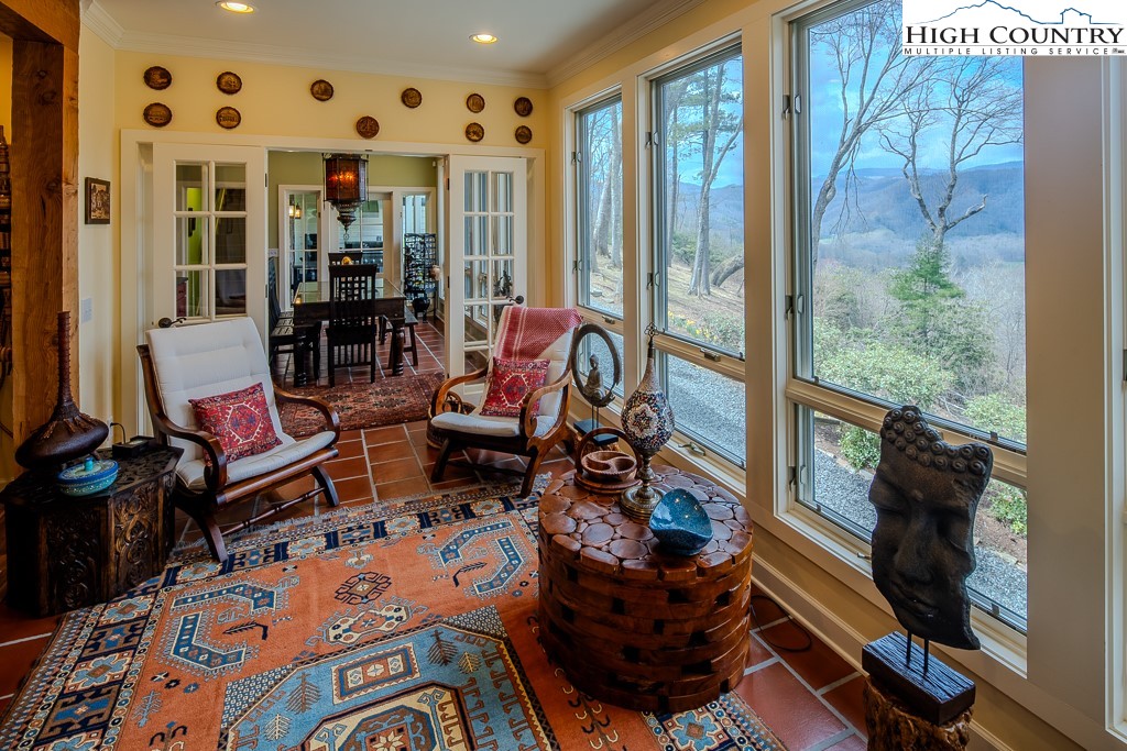 909 Daisy Ridge Road Banner Elk, NC 28604 - Photo 5 of 47 a outdoor space with patio the couches and a dining table with the garden view