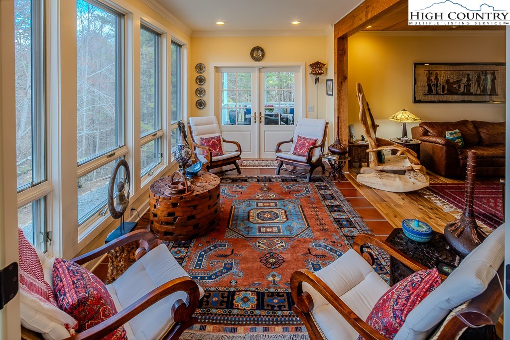 909 Daisy Ridge Road Banner Elk, NC 28604 - Photo 10 of 47 a very nice looking living room with furniture and floor to ceiling windows
