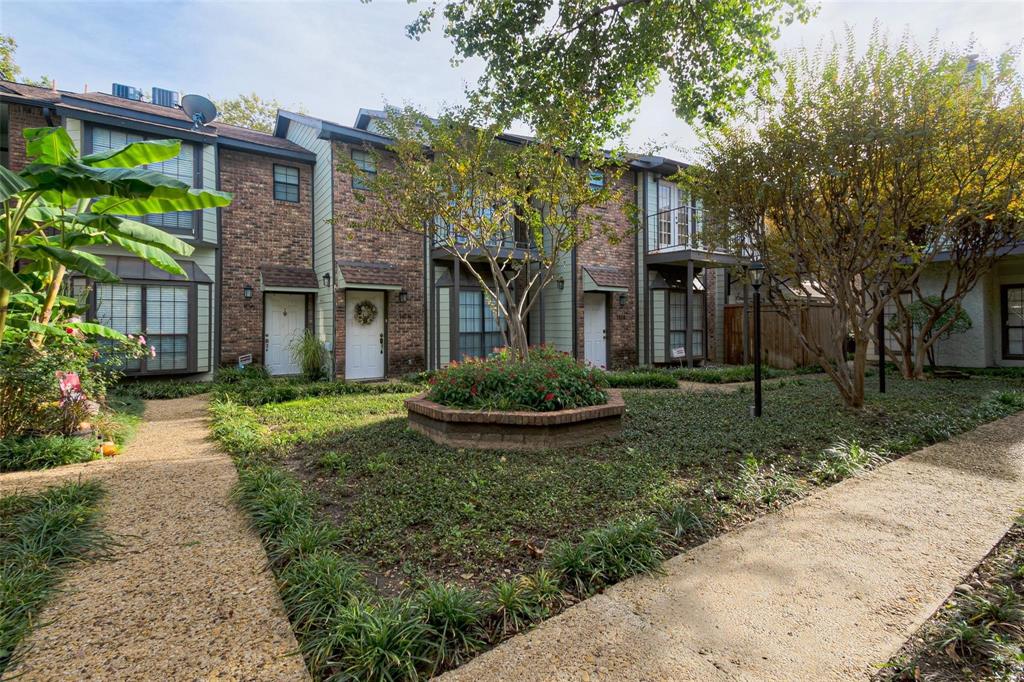3904 Rawlins Street, Unit 112 Dallas, TX 75219 - Photo 2 of 15 Brick and siding exterior featuring multiple units with white entry doors