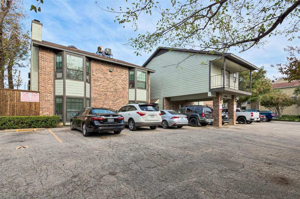 3904 Rawlins Street, Unit 112 Dallas, TX 75219 - Photo 3 of 15 Multi-story building featuring brick and siding exteriors, individual balconies with iron railings, and extensive window placements