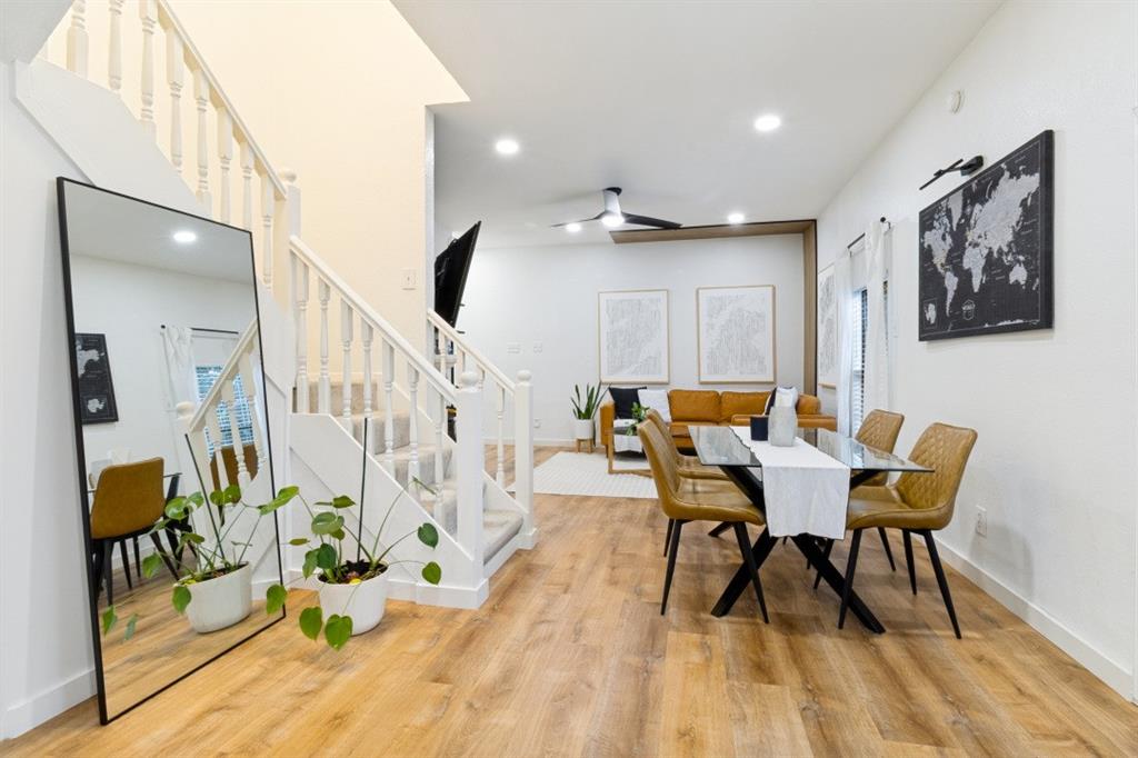 3904 Rawlins Street, Unit 112 Dallas, TX 75219 - Photo 7 of 15 Open-concept living area featuring wood-finish flooring, recessed lighting, and a white baluster staircase