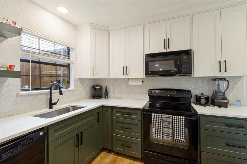 3904 Rawlins Street, Unit 112 Dallas, TX 75219 - Photo 8 of 15 Kitchen featuring two-tone cabinetry with white upper and olive green lower cabinets, white countertops, and a herringbone-patterned tile backsplash