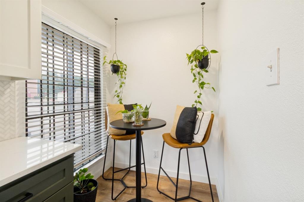 3904 Rawlins Street, Unit 112 Dallas, TX 75219 - Photo 9 of 15 Kitchen corner featuring a window with horizontal blinds, white countertop, and a white herringbone tile backsplash