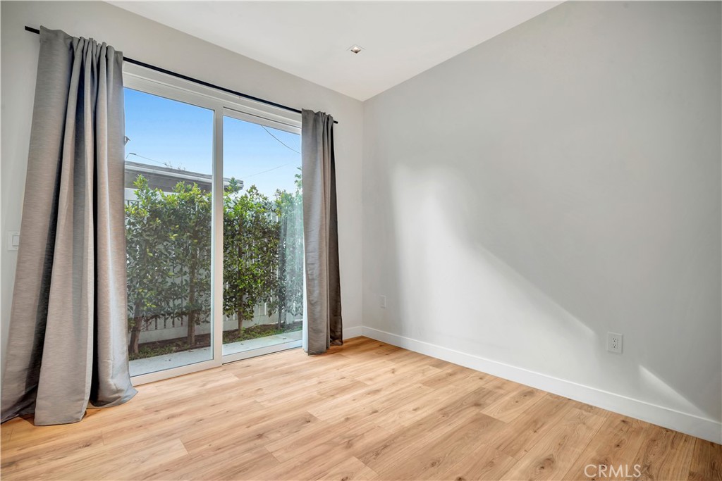6721 Rhea Reseda, CA 91335 - Photo 13 of 22 a view of an empty room with wooden floor and a window