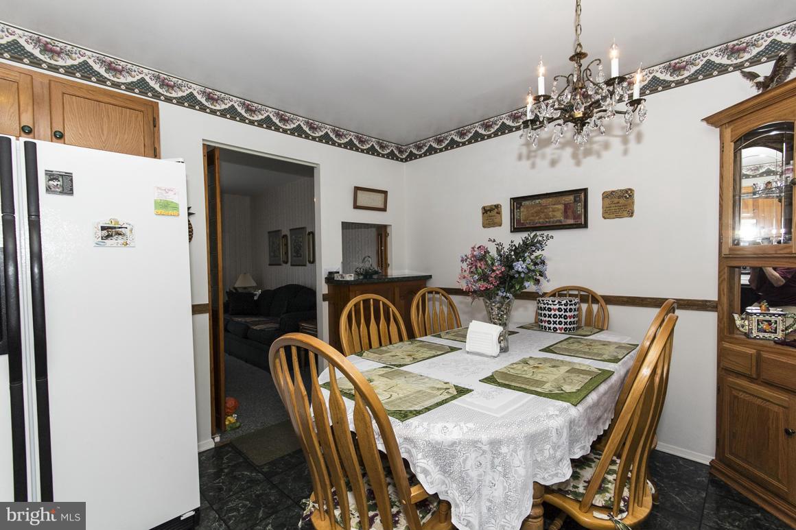 7116 Oliver Beach Road Baltimore, MD 21220 - Photo 14 of 30 a view of a dining room with furniture
