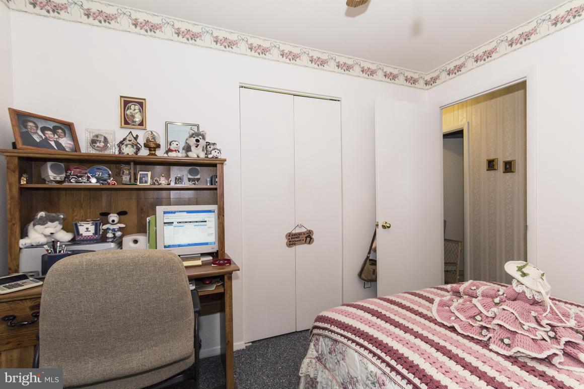 7116 Oliver Beach Road Baltimore, MD 21220 - Photo 22 of 30 a bedroom with a bed and a table