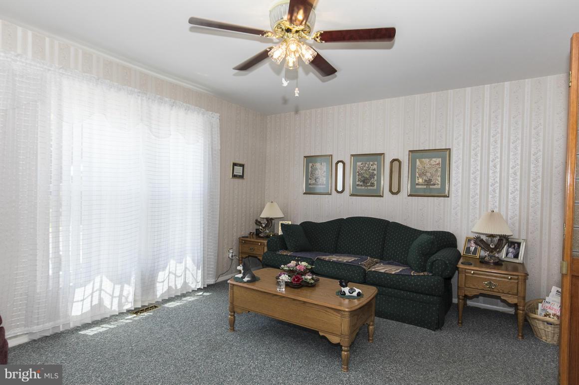 7116 Oliver Beach Road Baltimore, MD 21220 - Photo 8 of 30 a living room with furniture and a window