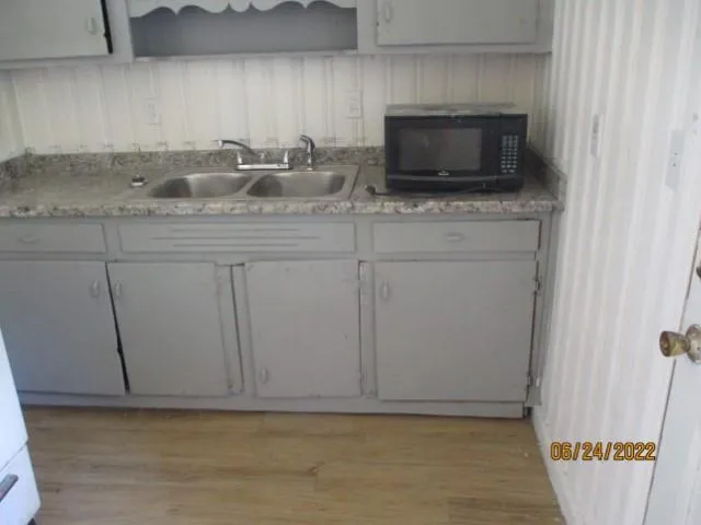 a kitchen with a sink and a microwave