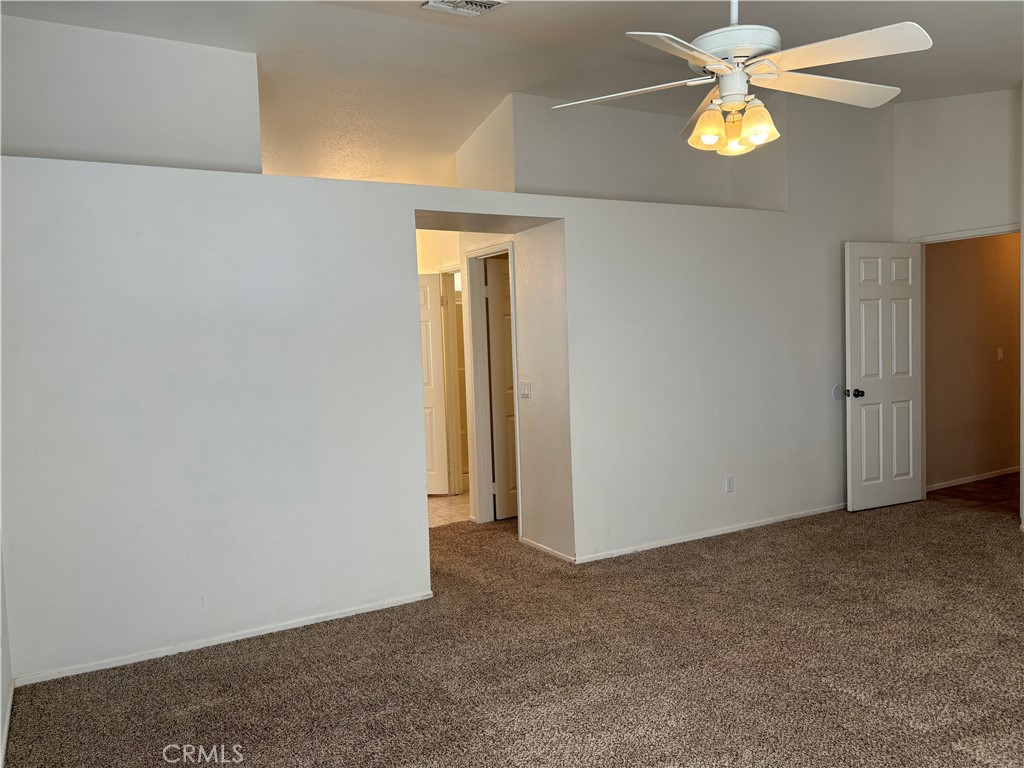 13001 August Circle Riverside, CA 92503 - Photo 22 of 37 an empty room with a chandelier fan and closet