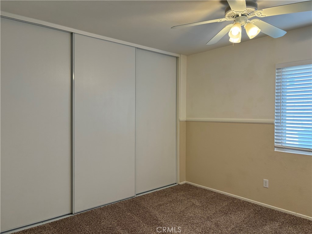 13001 August Circle Riverside, CA 92503 - Photo 26 of 37 an empty room with a window and chandelier fan