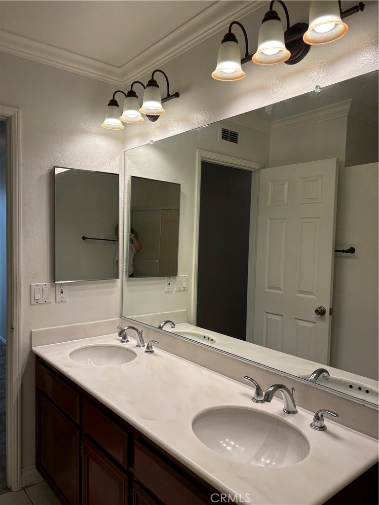 13001 August Circle Riverside, CA 92503 - Photo 28 of 37 a bathroom with a double vanity sink and a mirror