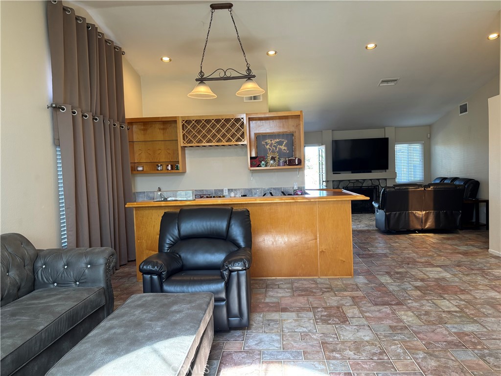 13001 August Circle Riverside, CA 92503 - Photo 8 of 37 a living room with furniture a flat screen tv and a chandelier