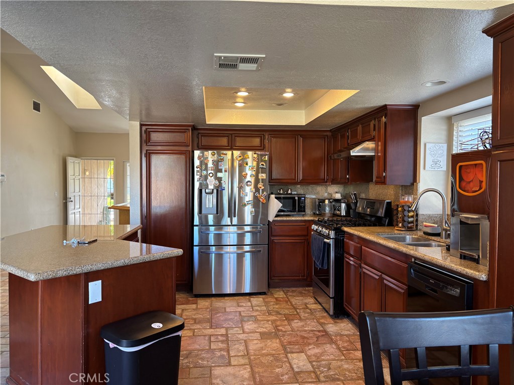 13001 August Circle Riverside, CA 92503 - Photo 10 of 37 a kitchen with stainless steel appliances granite countertop a stove refrigerator and cabinets