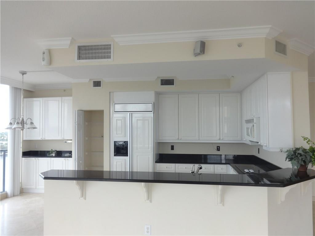 100 South Birch Road, Unit 1106B Fort Lauderdale, FL 33316 - Photo 19 of 34 a kitchen with granite countertop a sink and cabinets