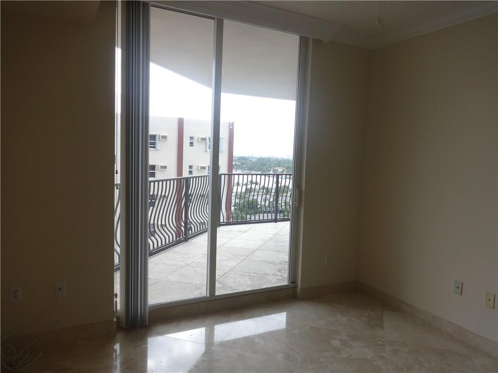 100 South Birch Road, Unit 1106B Fort Lauderdale, FL 33316 - Photo 22 of 34 an empty room with sliding glass door and mountain view