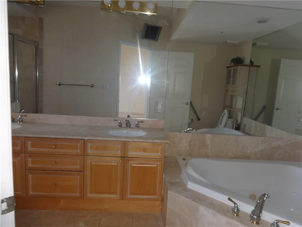 100 South Birch Road, Unit 1106B Fort Lauderdale, FL 33316 - Photo 26 of 34 a bathroom with a double vanity sink and a mirror