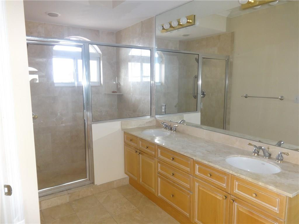 100 South Birch Road, Unit 1106B Fort Lauderdale, FL 33316 - Photo 27 of 34 a bathroom with a double vanity sink and mirror