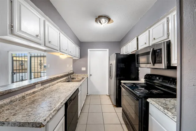 a kitchen with stainless steel appliances granite countertop a stove and a refrigerator