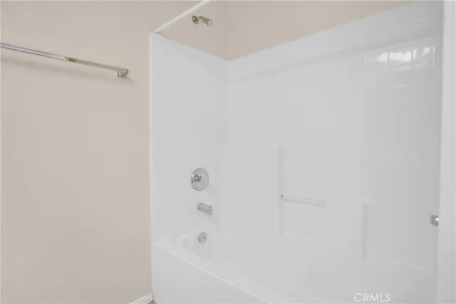 a view of a room with a ceiling fan and a window