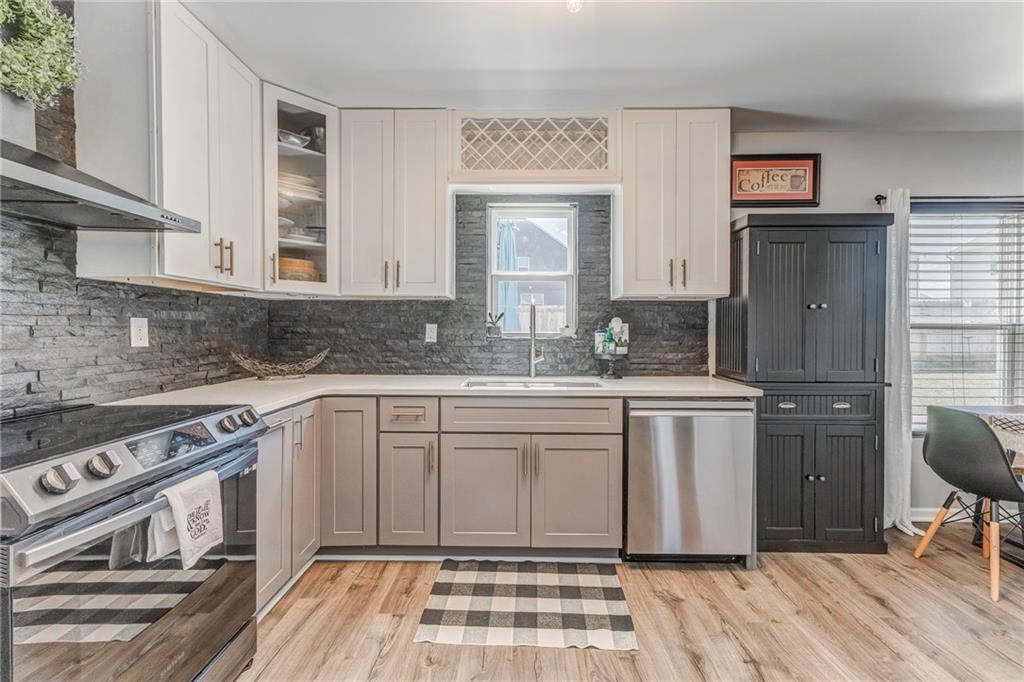 803 Riverside Drive Calhoun, GA 30701 - Photo 12 of 59 a kitchen with stainless steel appliances granite countertop a stove a sink and a refrigerator
