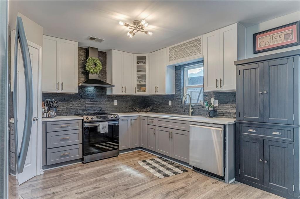 803 Riverside Drive Calhoun, GA 30701 - Photo 14 of 59 a kitchen with a stove cabinets and a sink