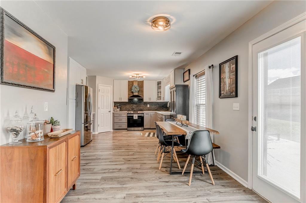 803 Riverside Drive Calhoun, GA 30701 - Photo 19 of 59 a kitchen with stainless steel appliances refrigerator dining table and chairs