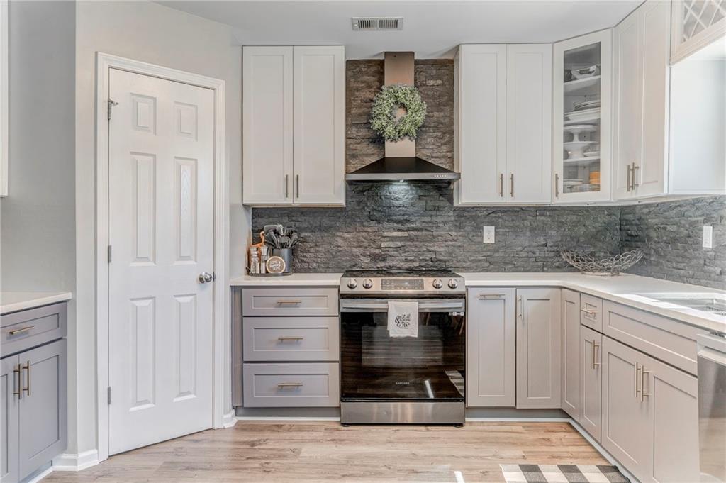 803 Riverside Drive Calhoun, GA 30701 - Photo 10 of 59 a kitchen with appliances cabinets and a counter top space