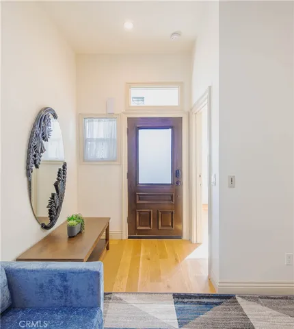 a room with painting on the wall and a window