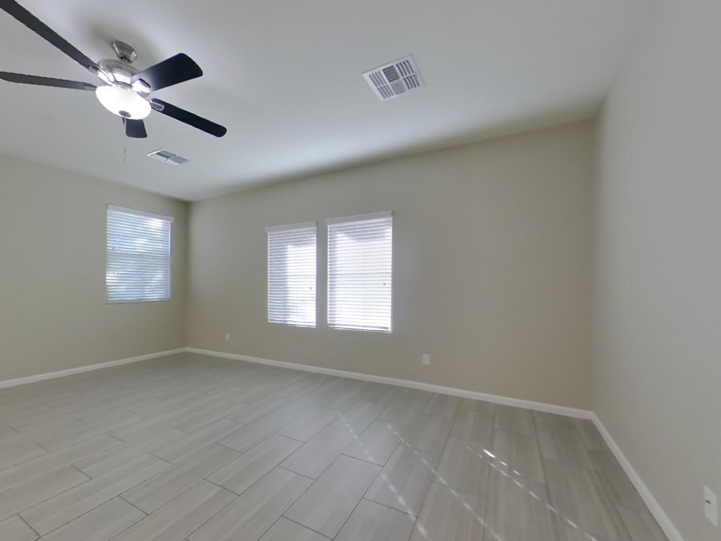 12565 West Via Dona Road Peoria, AZ 85383 - Photo 2 of 17 an empty room with windows and fan