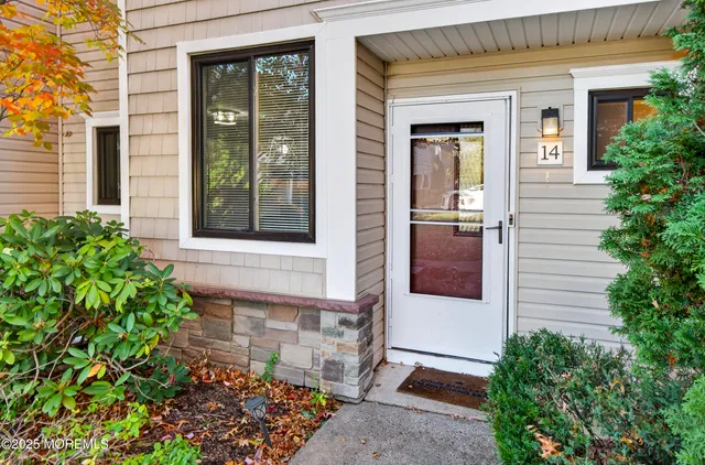 front view of of the house with a potted plant