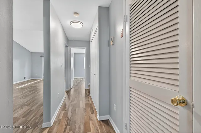 a view of a hallway with wooden floor