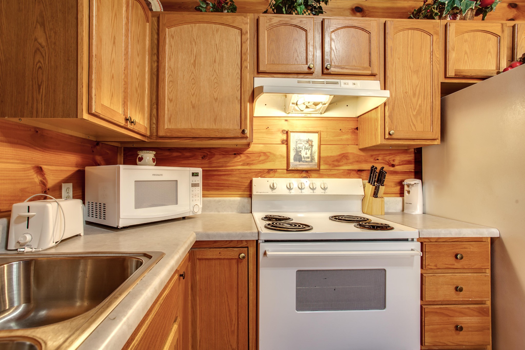 2036 Ridge Road, Unit SUITE 6 Pigeon Forge, TN 37863 - Photo 8 of 29 a kitchen with stainless steel appliances granite countertop a sink and a stove
