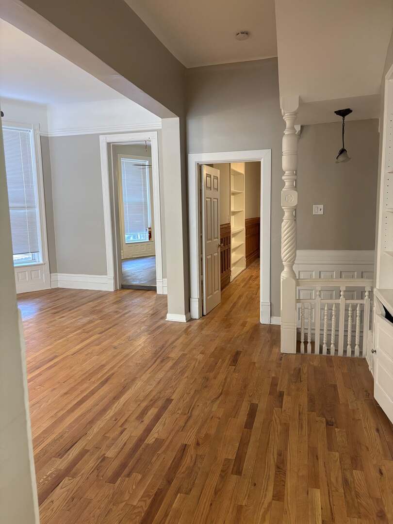 5136 South Blackstone Avenue, Unit 1F Chicago, IL 60615 - Photo 2 of 13 a view of a room with wooden floor and a bathroom