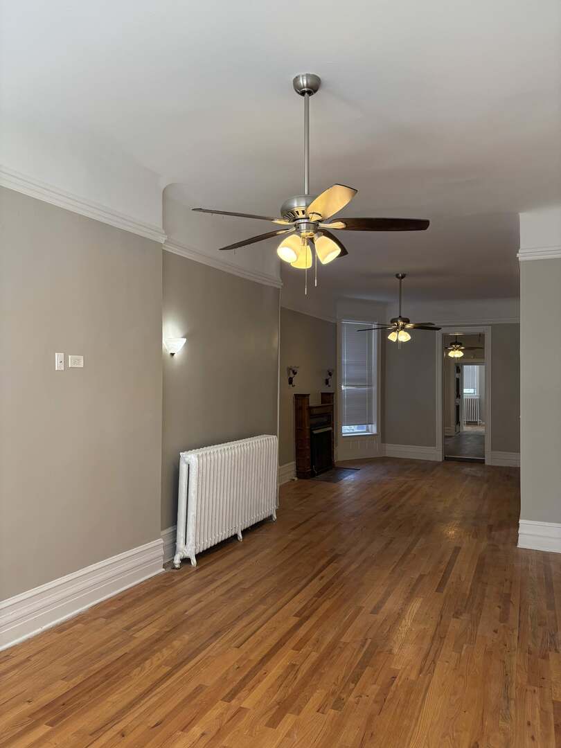 5136 South Blackstone Avenue, Unit 1F Chicago, IL 60615 - Photo 3 of 13 a view of an empty room with a window and a chandelier